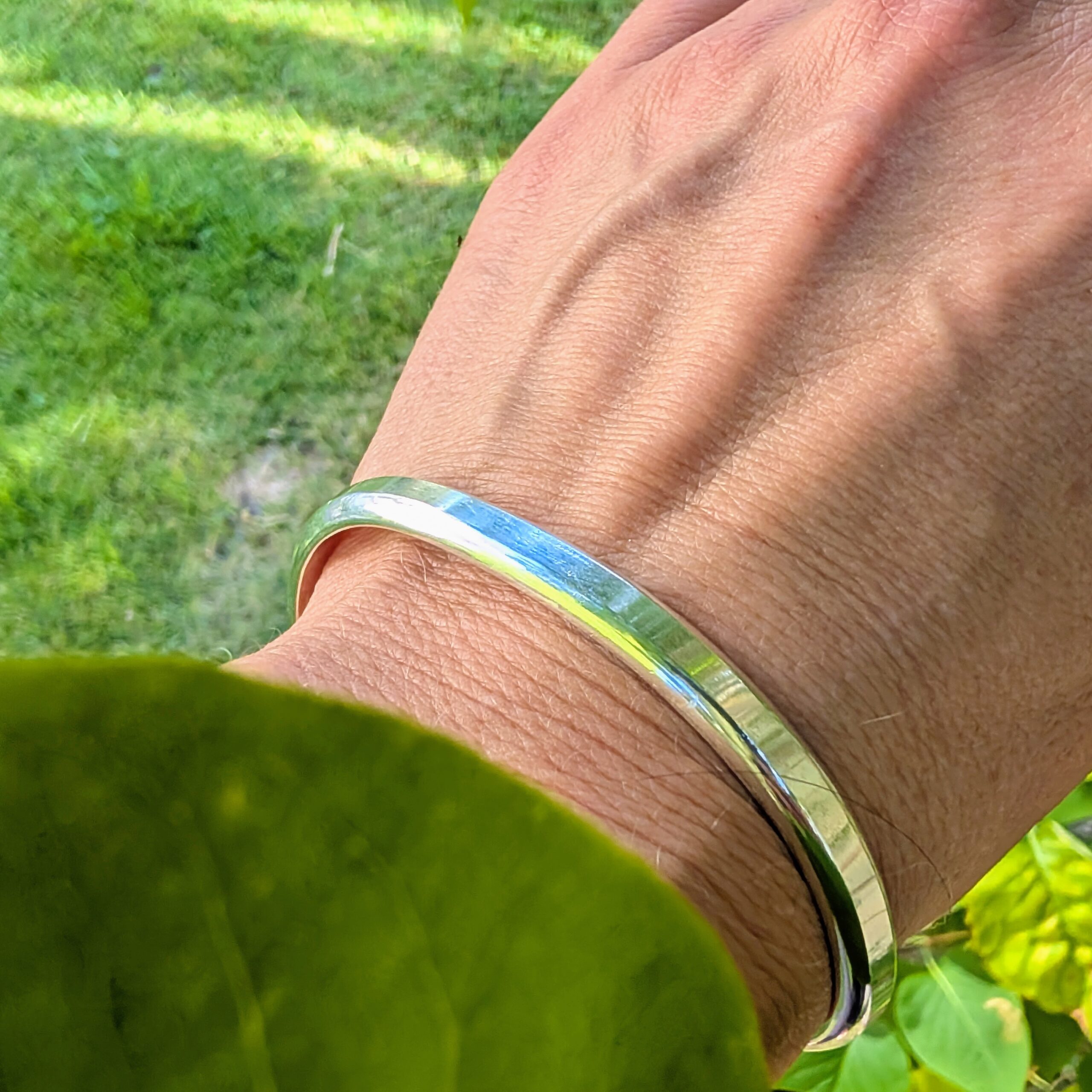 Stilrent silverarmband - PXL 20260821 1402153892 scaled stelt silverarmband på kvinnas namn utomhus